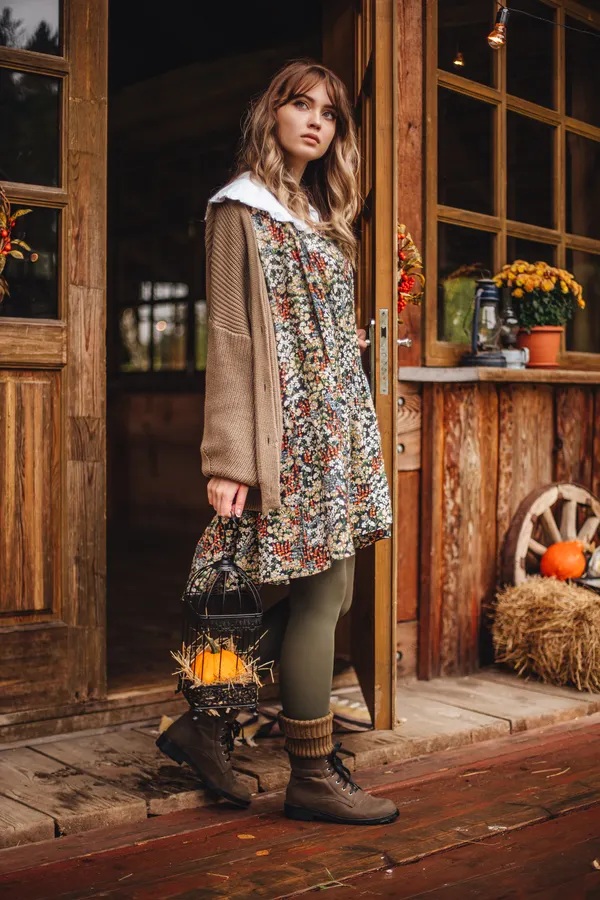 Woman wearing a floral midi dress with brown suede ankle boots