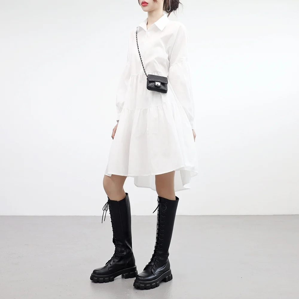 Woman in white shirt dress with combat boots