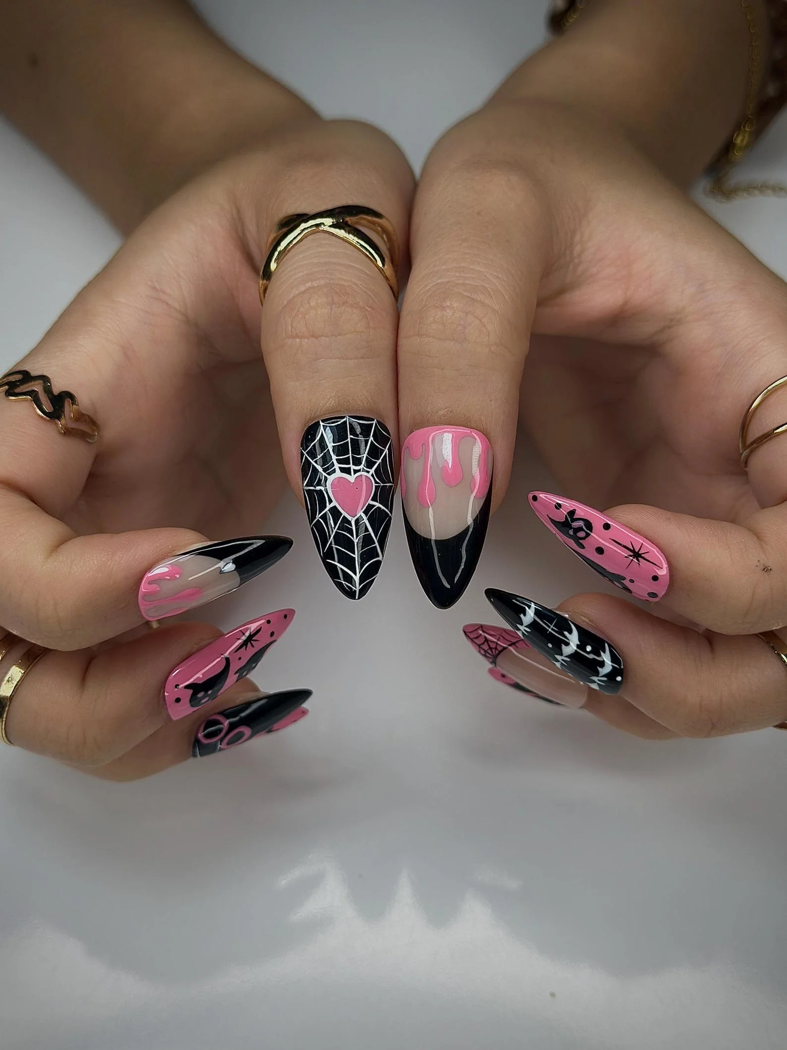 Pink ghost nail art on black nails Halloween