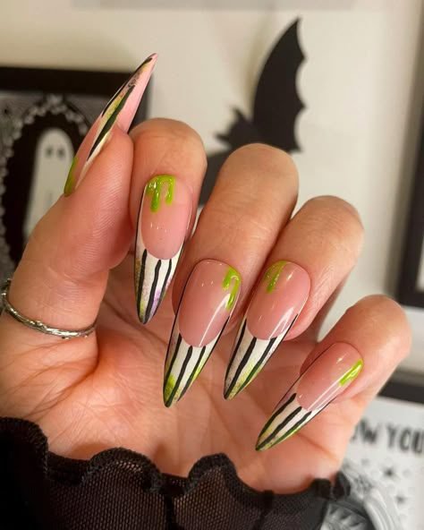 Pink and black striped Halloween nails