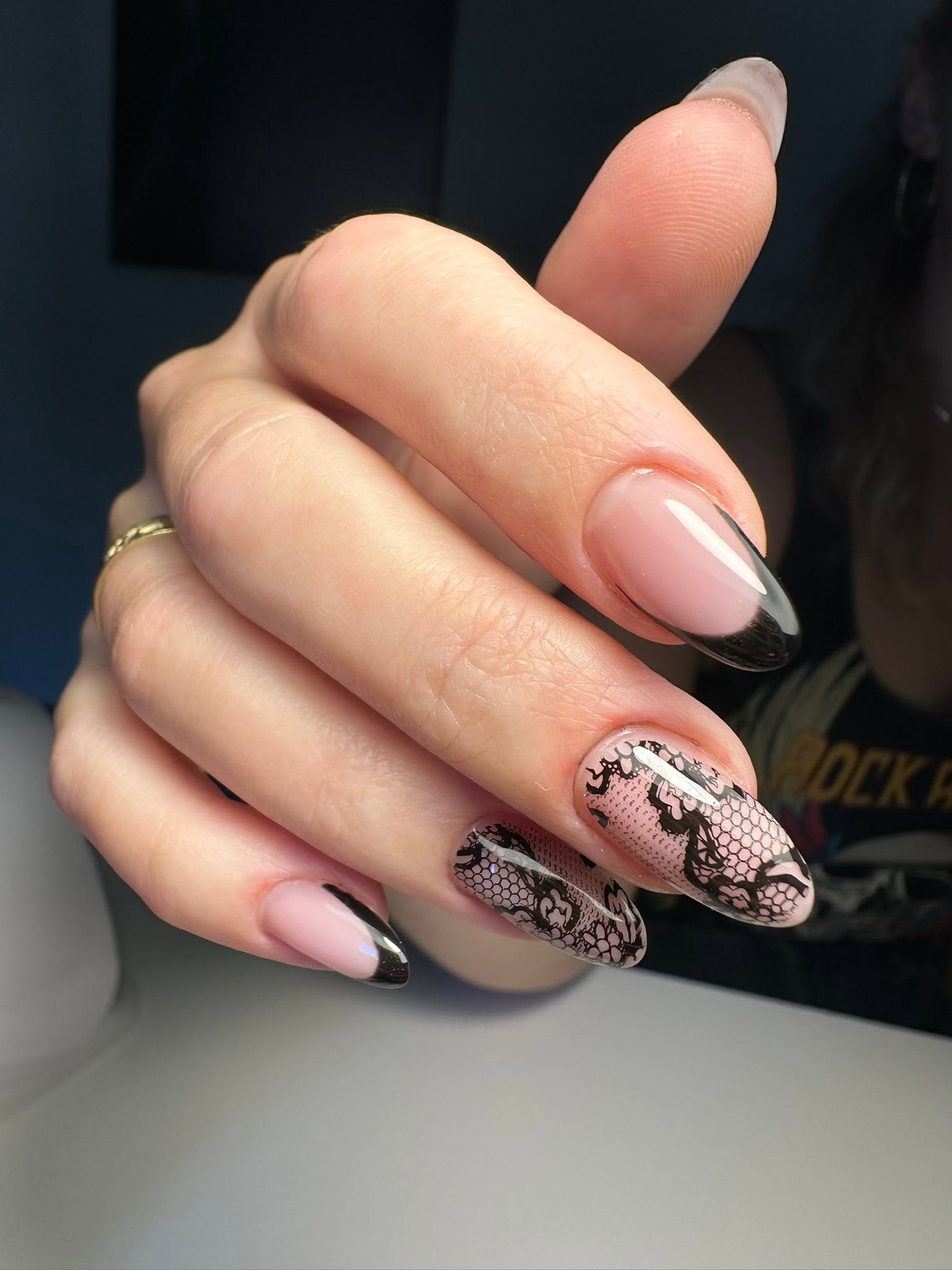 Black lace nail art over pink nails