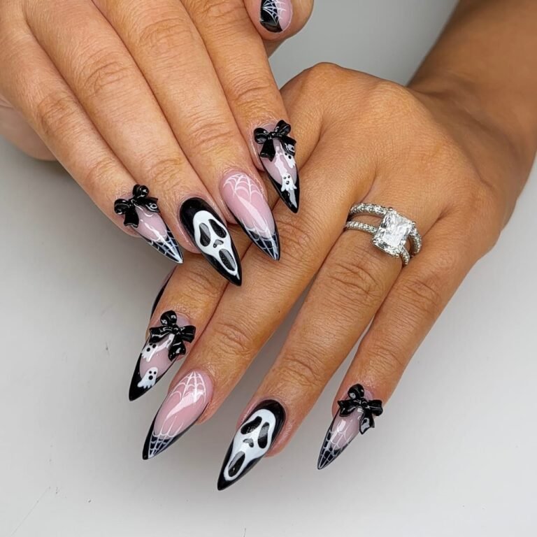 Black bow nail art on pink coquette Halloween nails