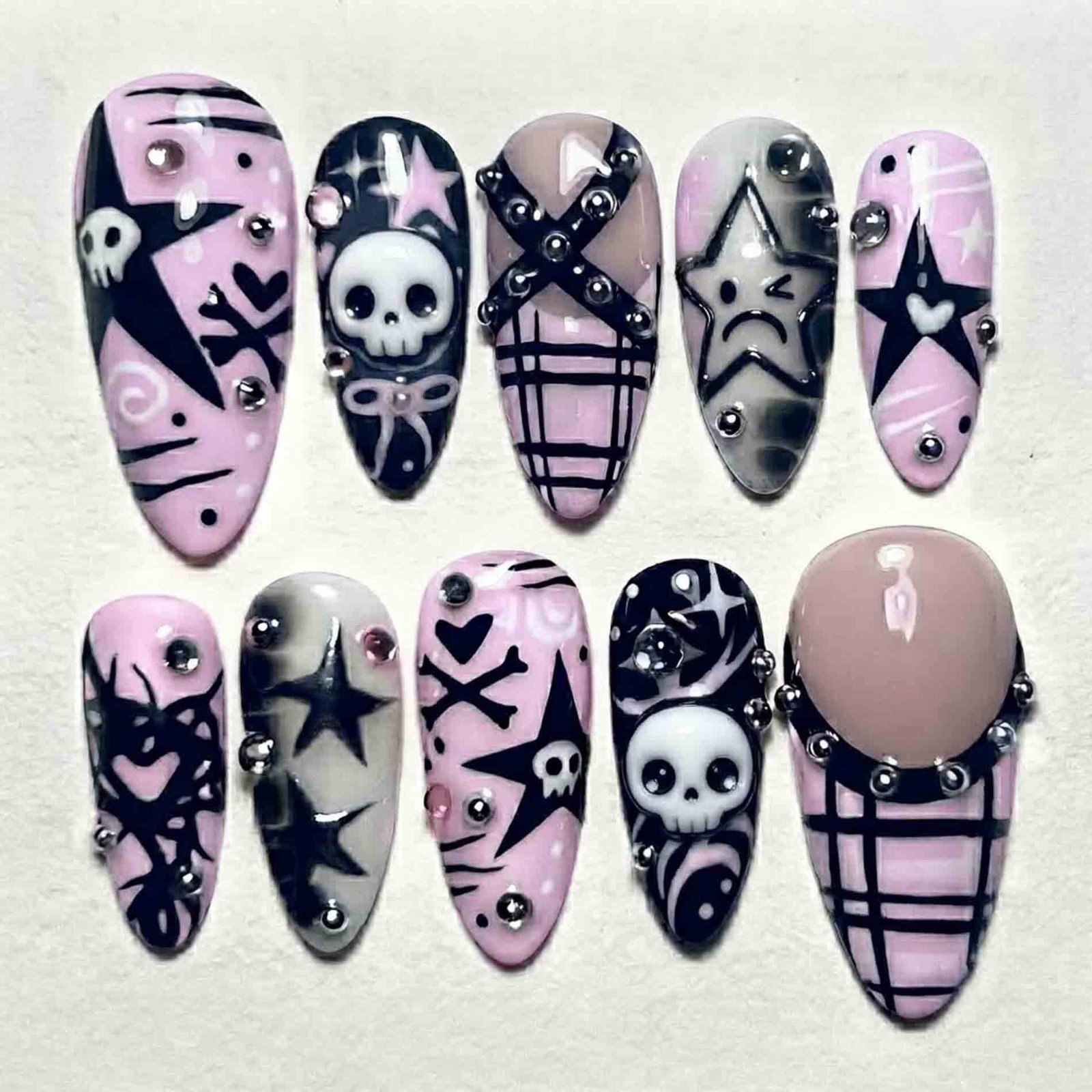 Pink skull nail art on black Halloween nails