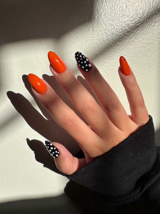 Orange and black polka dot halloween nails for kids