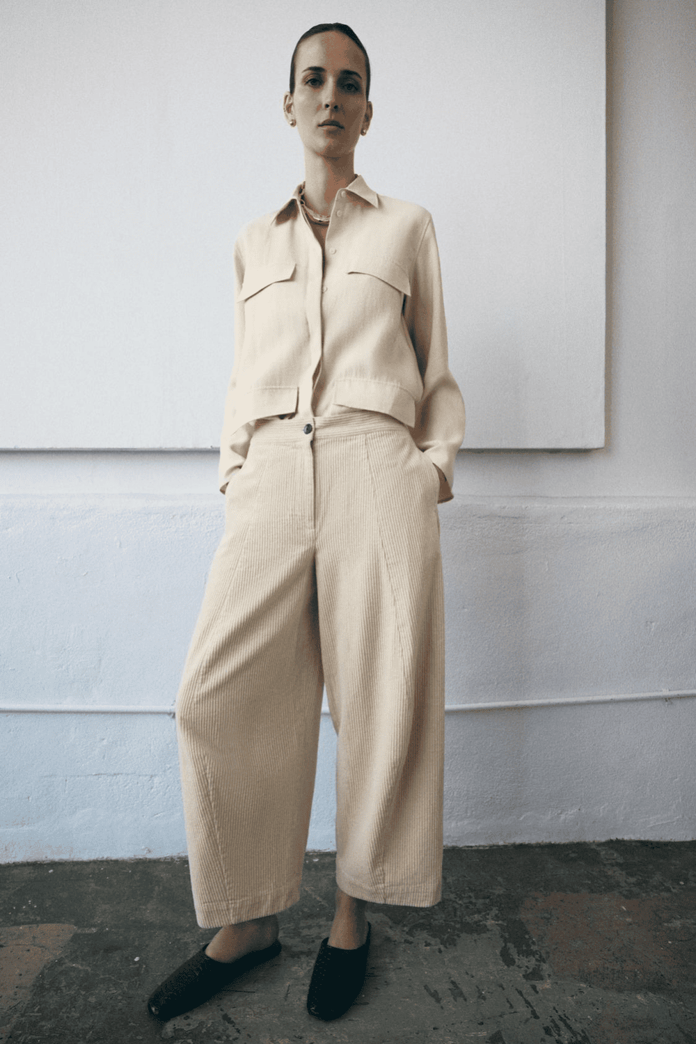 Woman in chambray shirt with cream corduroy trousers
