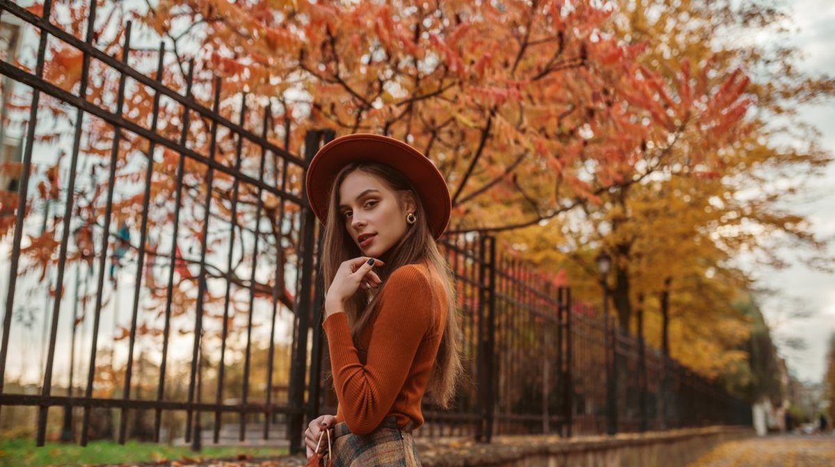 Woman wearing orange and brown for an autumn game day
