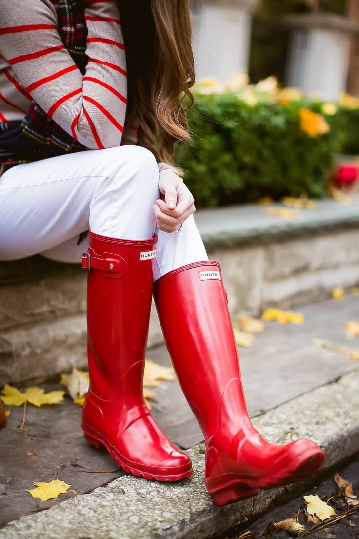Woman in red Hunter rain boots with a neutral outfit