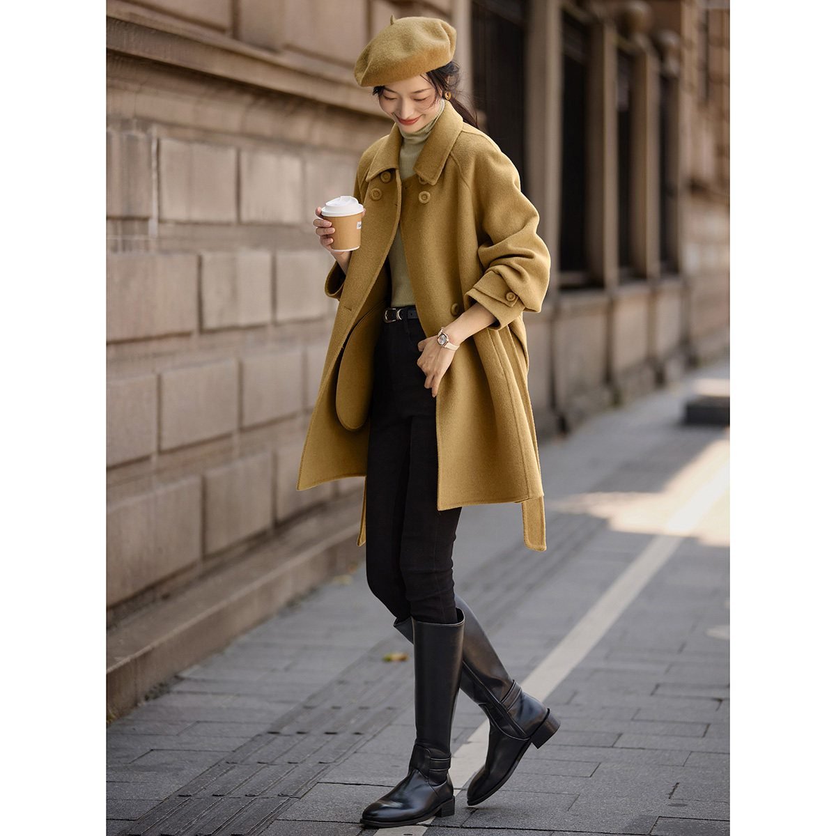 Woman wearing Hunter boots with a wool coat and beret