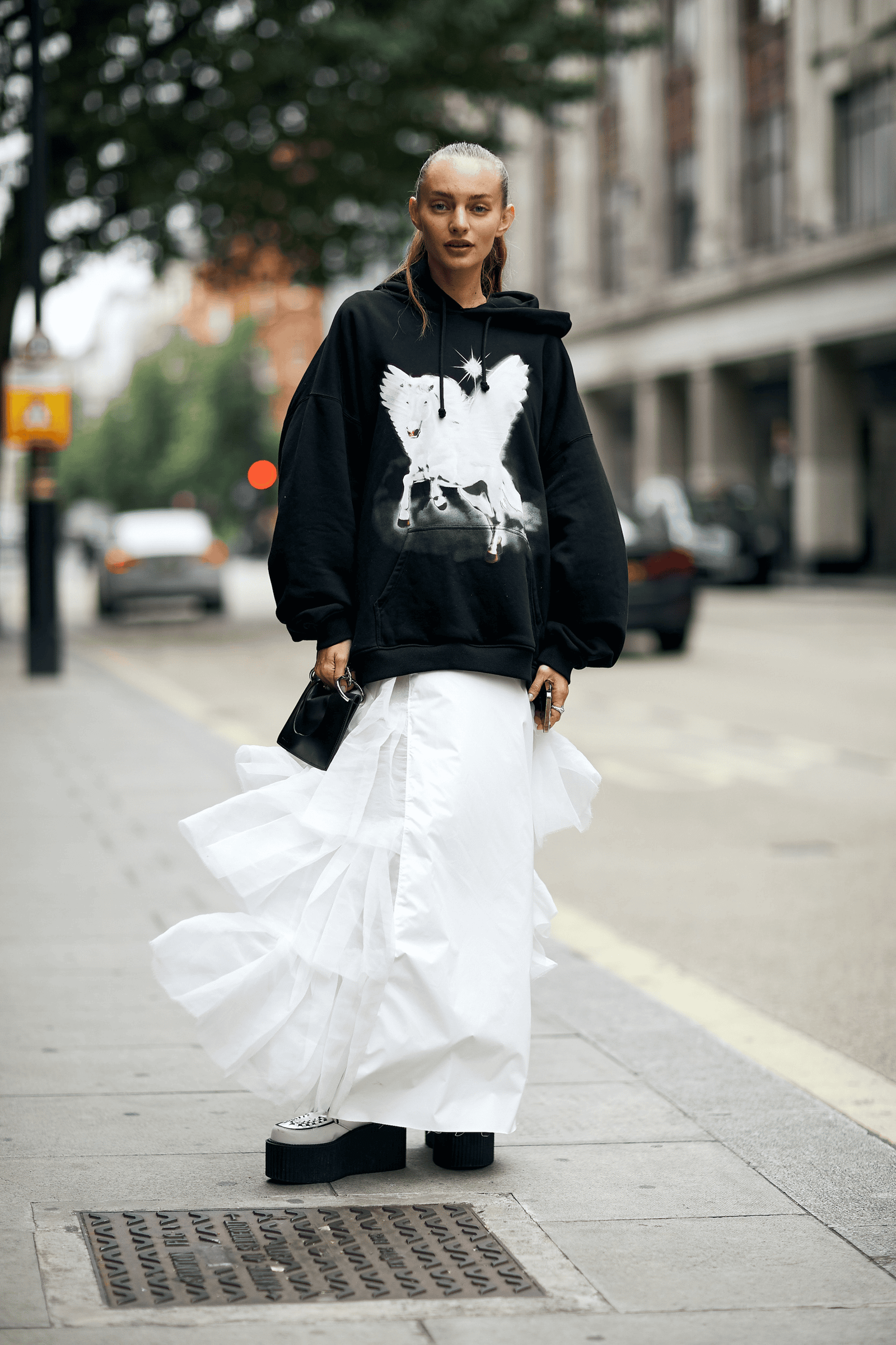 Woman in a tulle skirt with an oversized hoodie