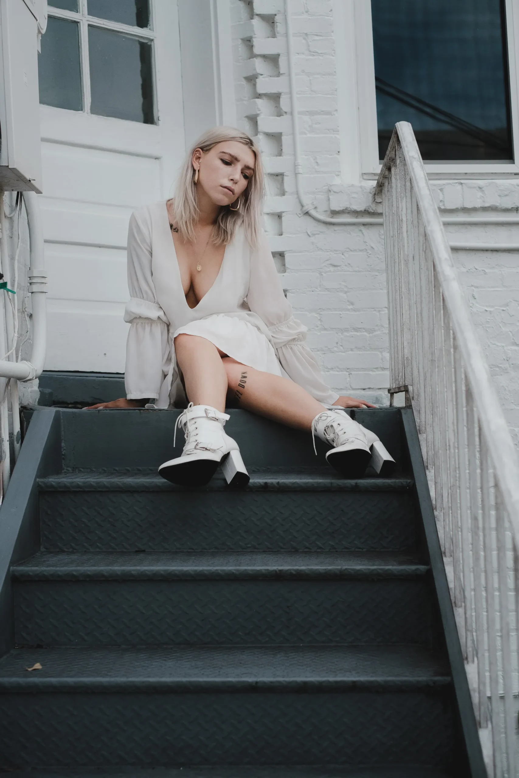 Woman wearing a white dress with rugged chunky boots