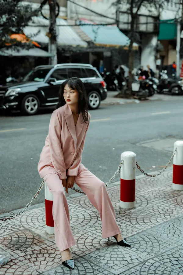 Woman wearing a blazer over a satin pajama set street style