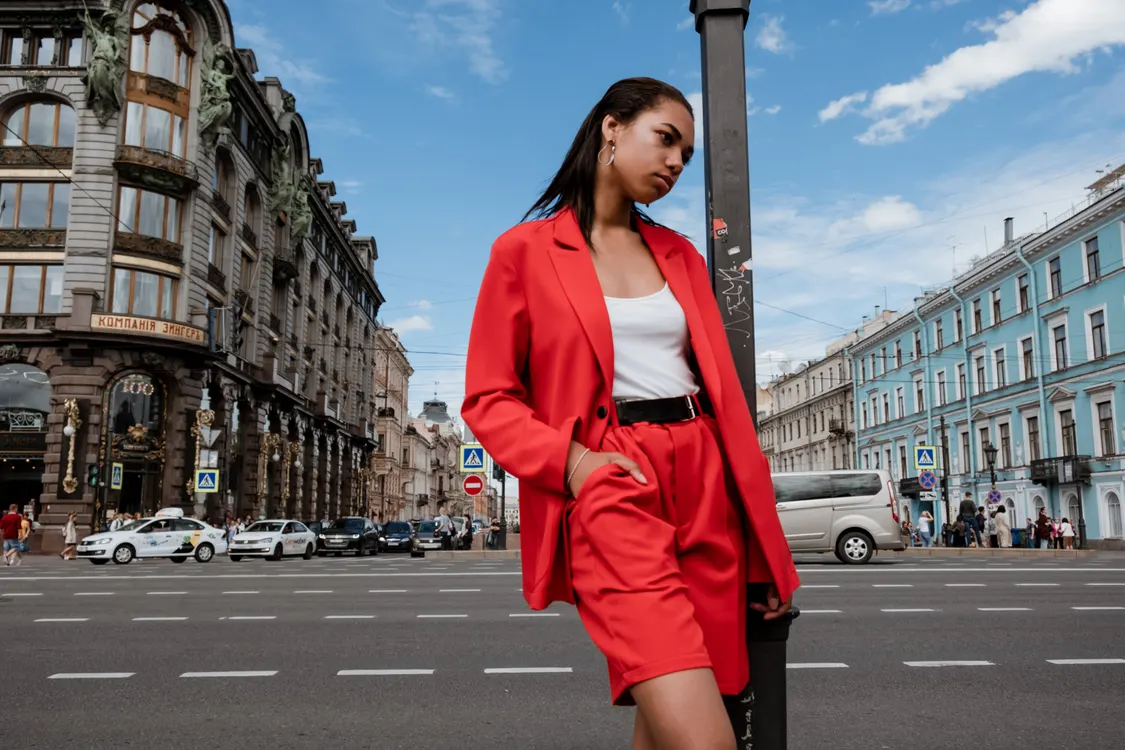 Woman wearing a tuxedo blazer with denim shorts
