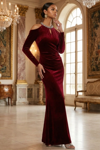 Woman wearing a burgundy velvet evening gown with dramatic drape
