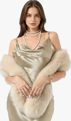 Woman wearing a champagne satin slip dress with a faux fur stole