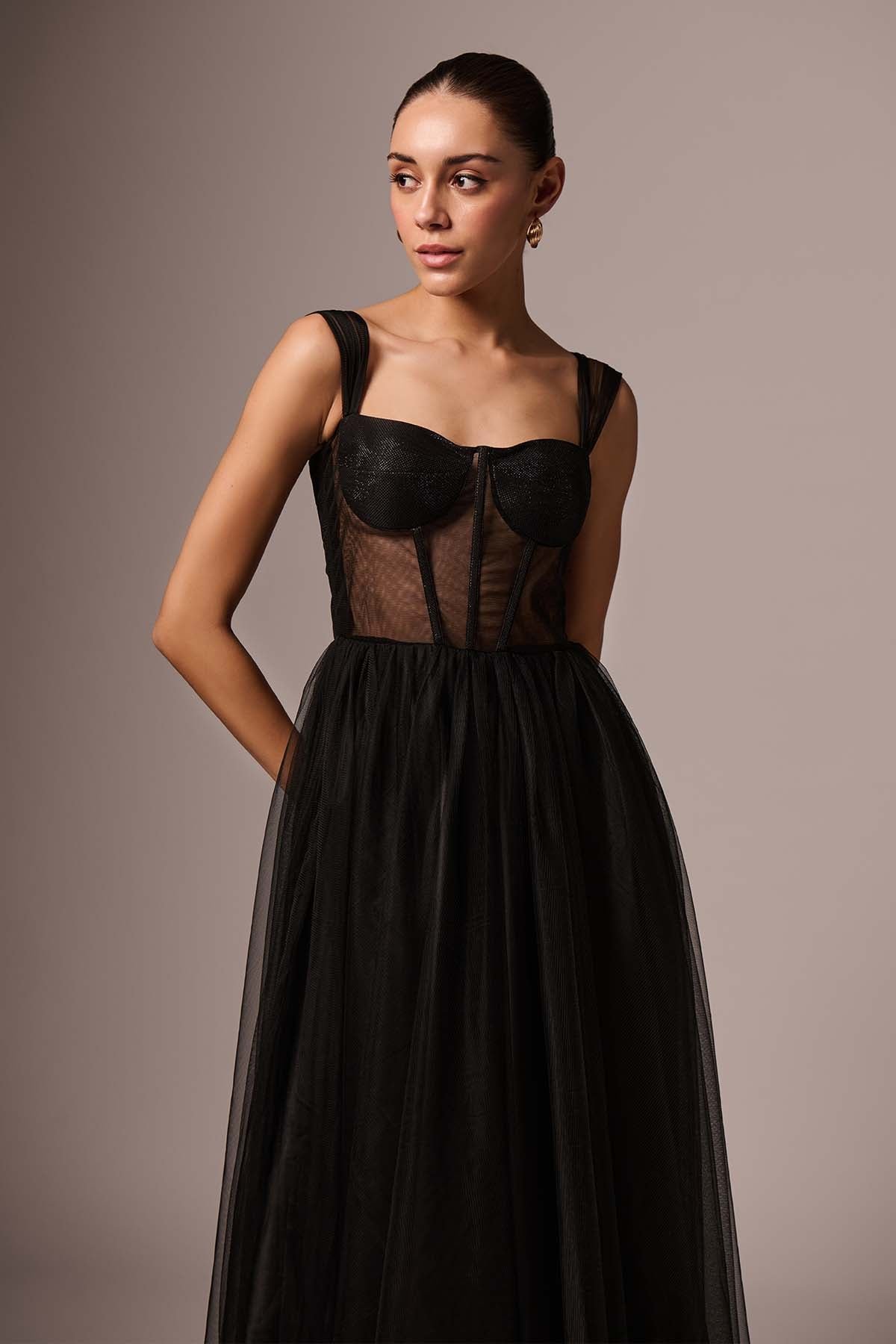 Woman wearing a corset top with a full tulle skirt