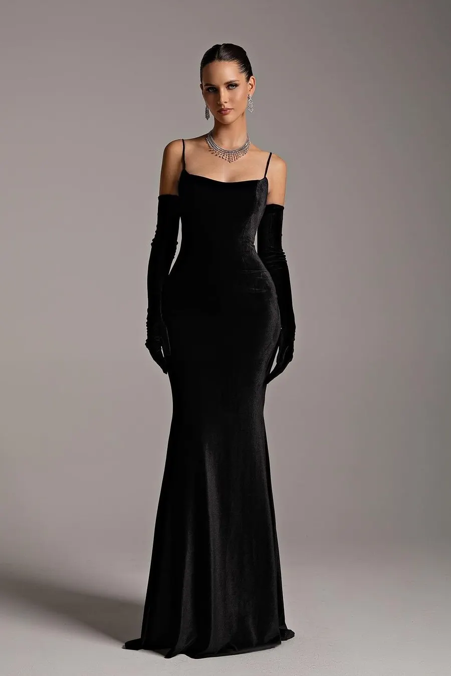 Woman wearing long black opera gloves with an evening dress