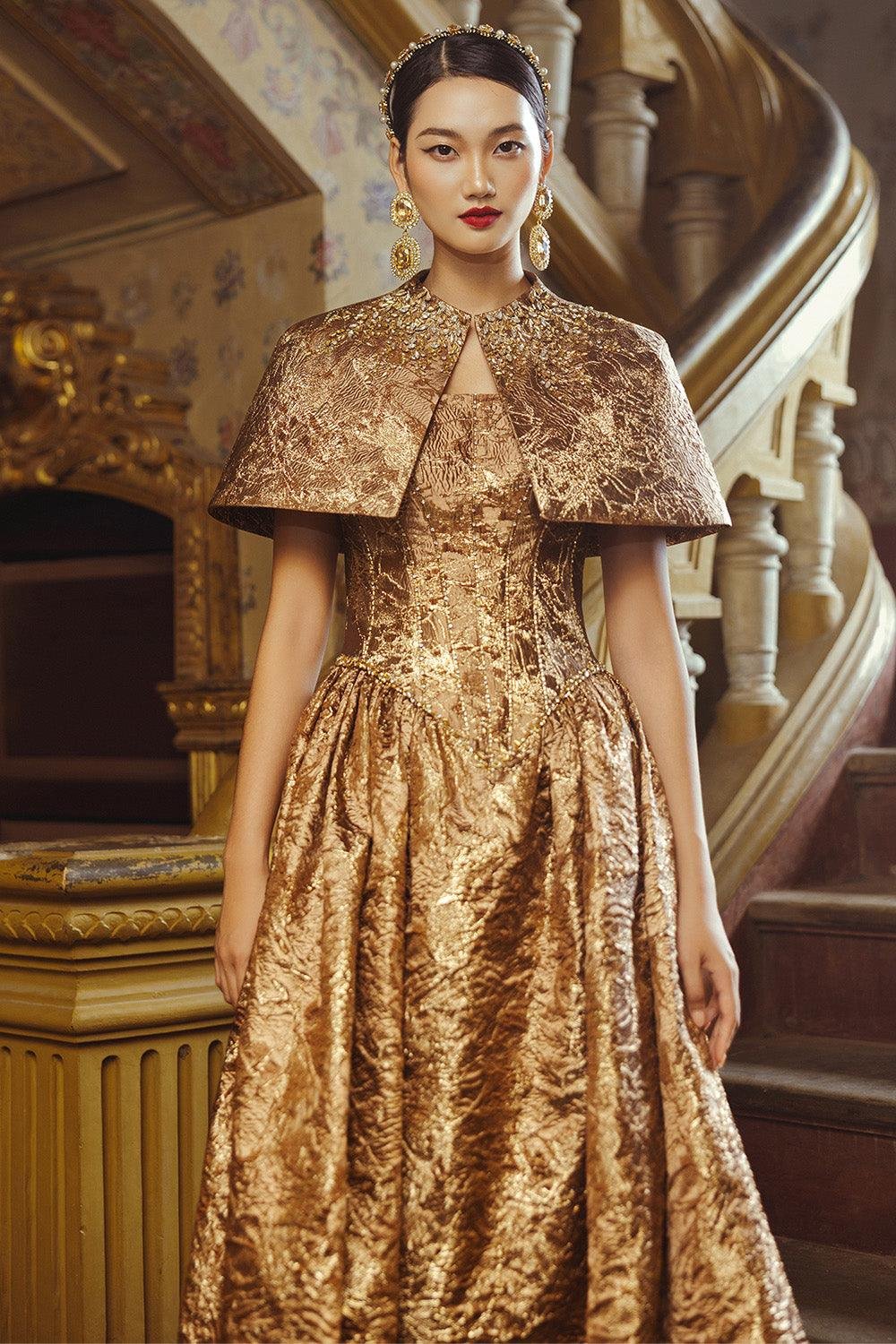 Woman wearing a baroque brocade dress with gold detailing