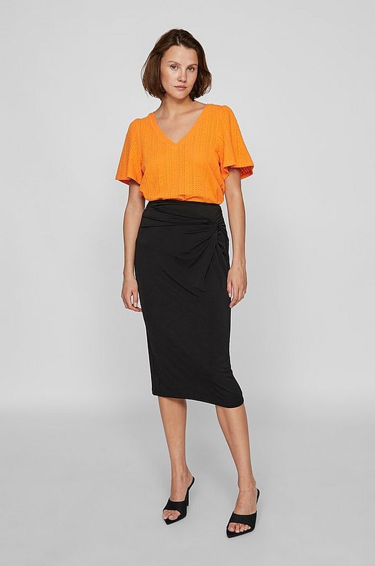 Orange cardigan over black dress fall outfit