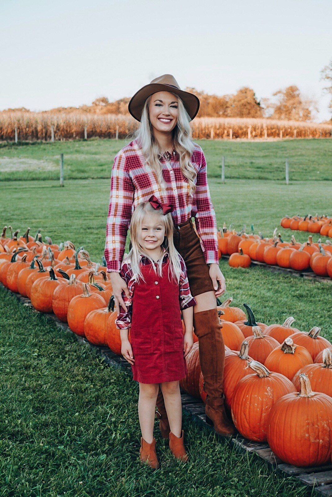 Mom and toddler in olive utility jackets and striped tees
