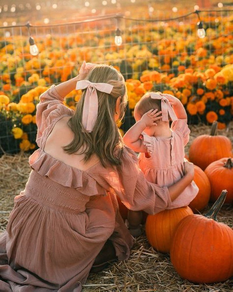 Mom and toddler in black and orange halloween inspired outfits
