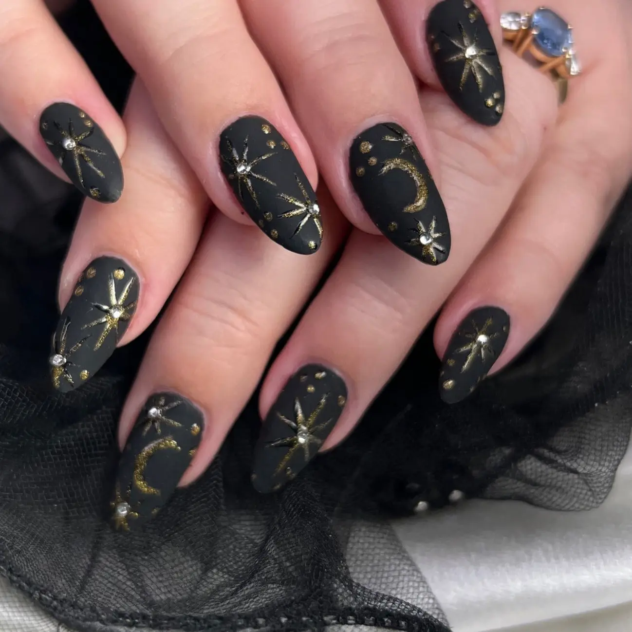 Matte black whimsigoth nails with gold stars
