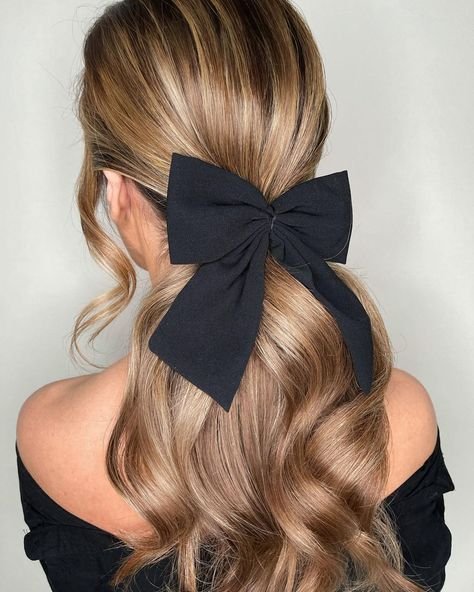 Half up hairstyle with bow for homecoming