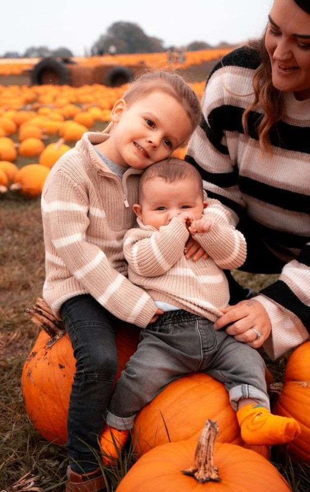 Mom and toddler in sunflower yellow dresses with denim jackets