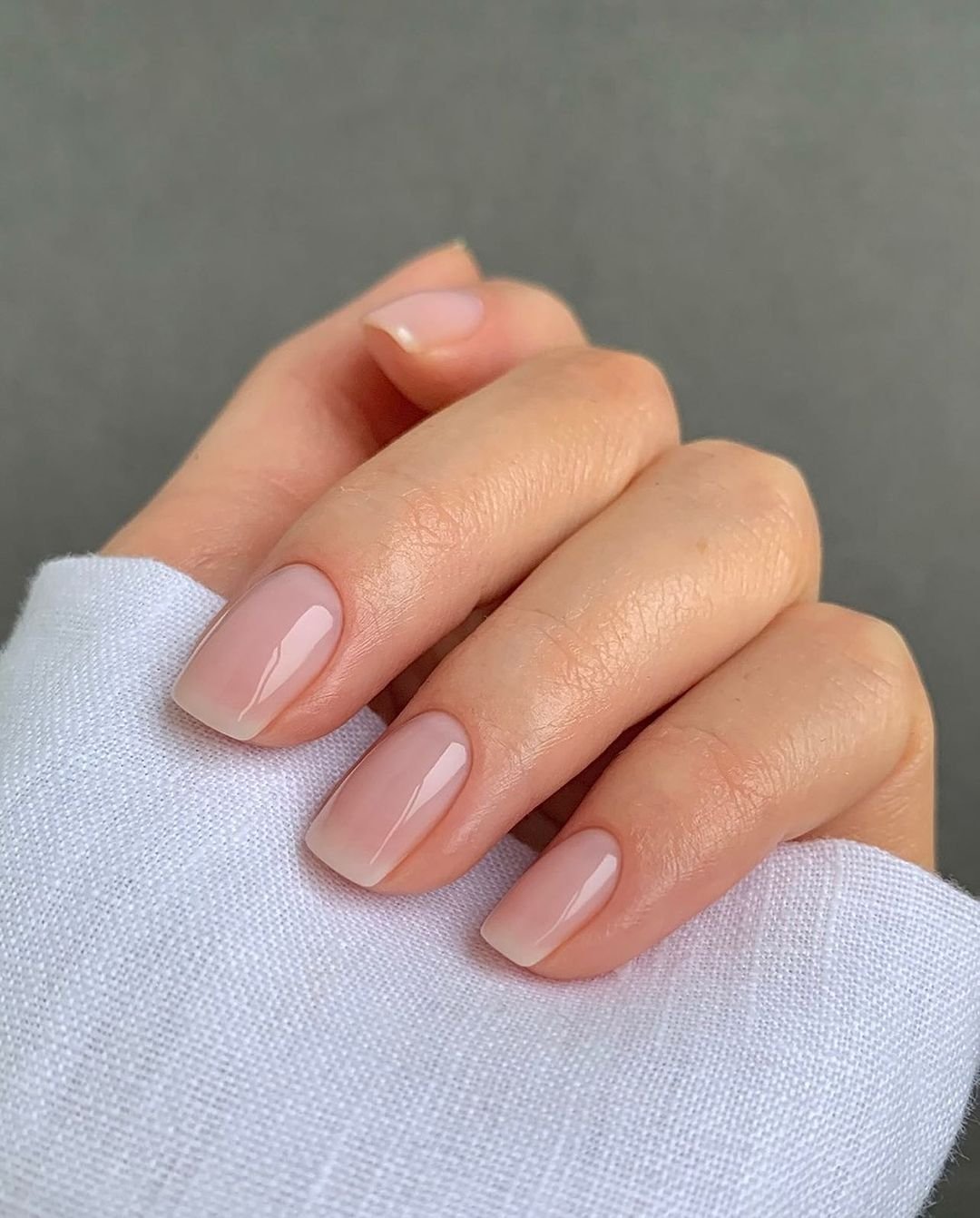 Satin-finish nude nails, neither matte nor glossy