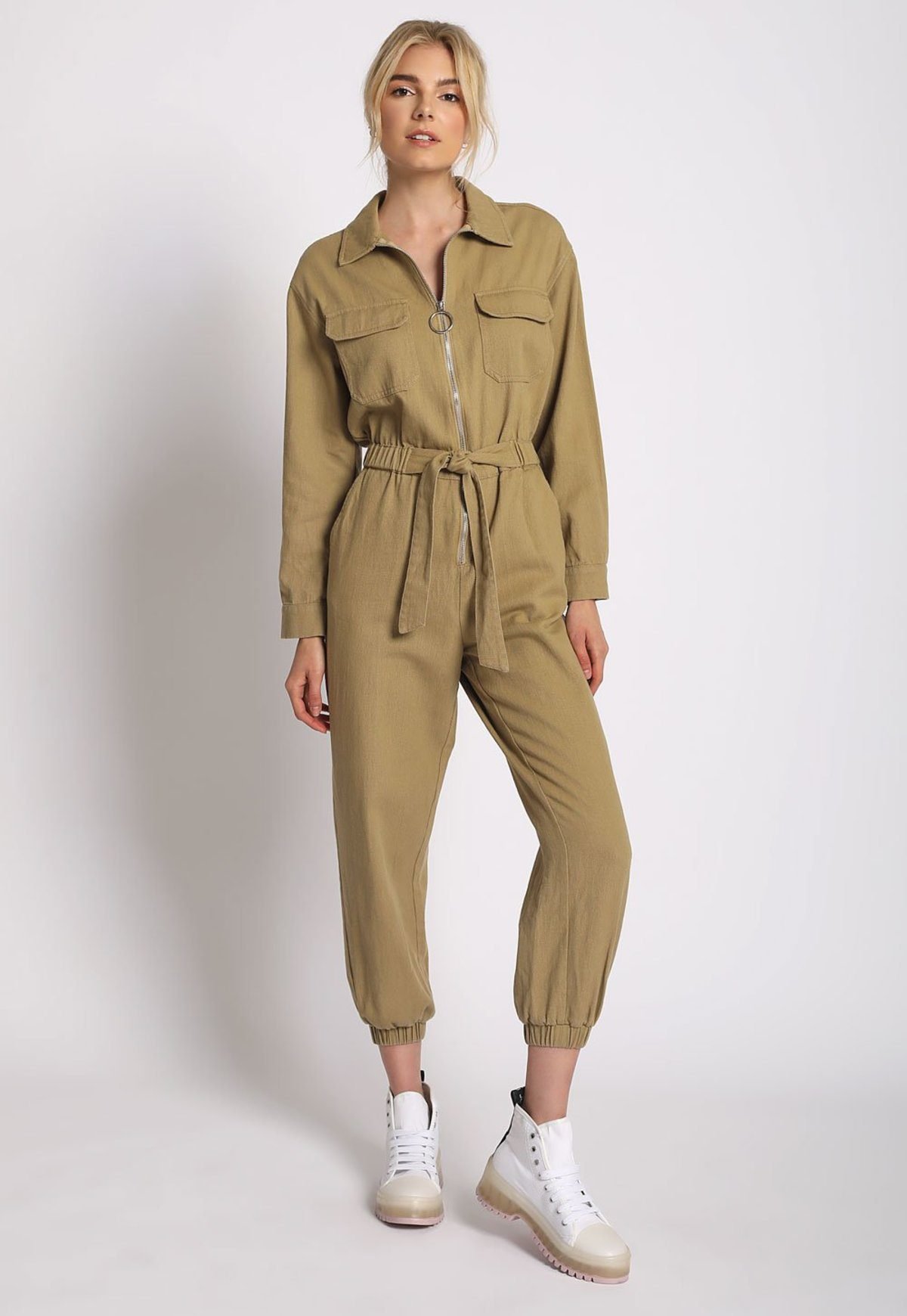 Woman in khaki utility jumpsuit