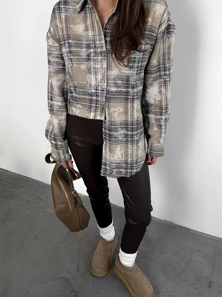 Woman in oversized utility shirt with faux leather leggings