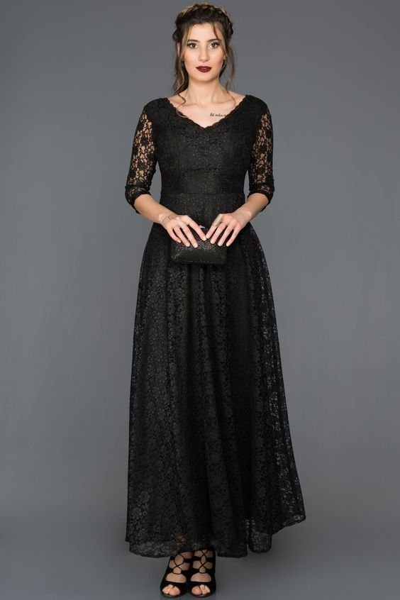 Woman wearing a black lace midi dress gothic elegant style
