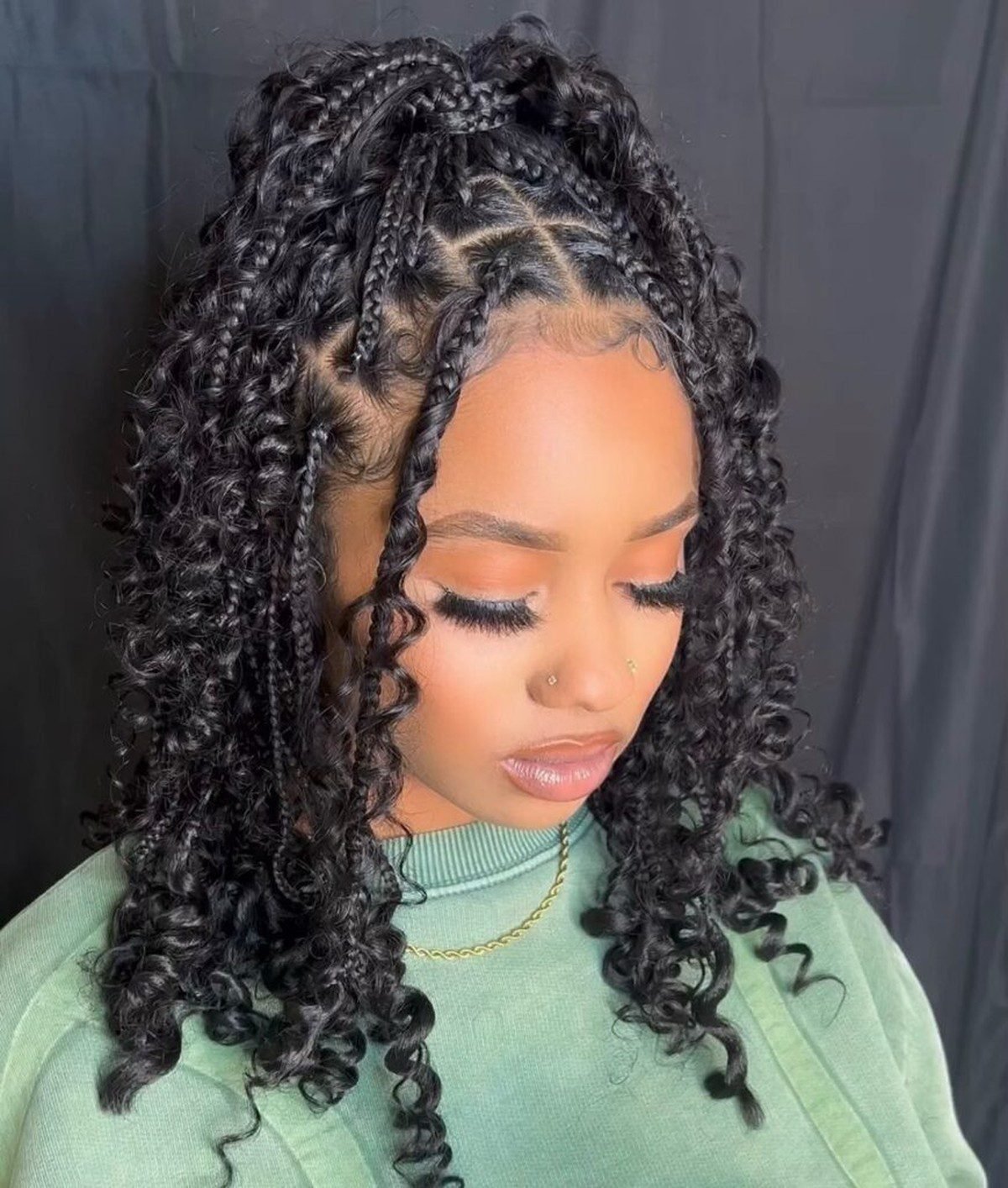 Black woman with knotless braids in a half up hairstyle