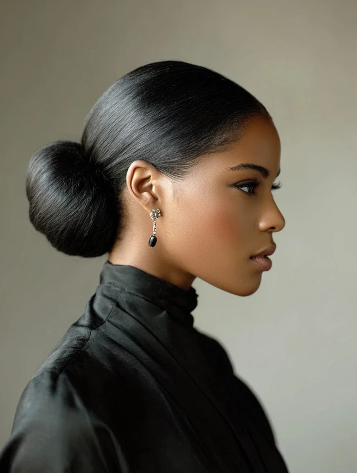 Black woman with a sleek low bun hairstyle