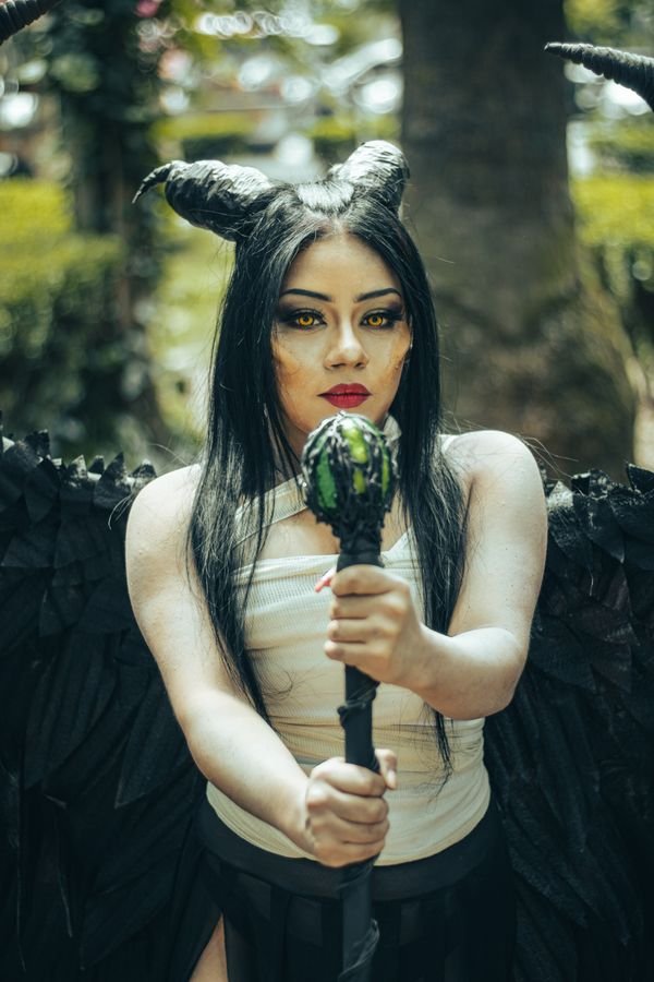Woman wearing a black villainess baddie Halloween costume with blazer