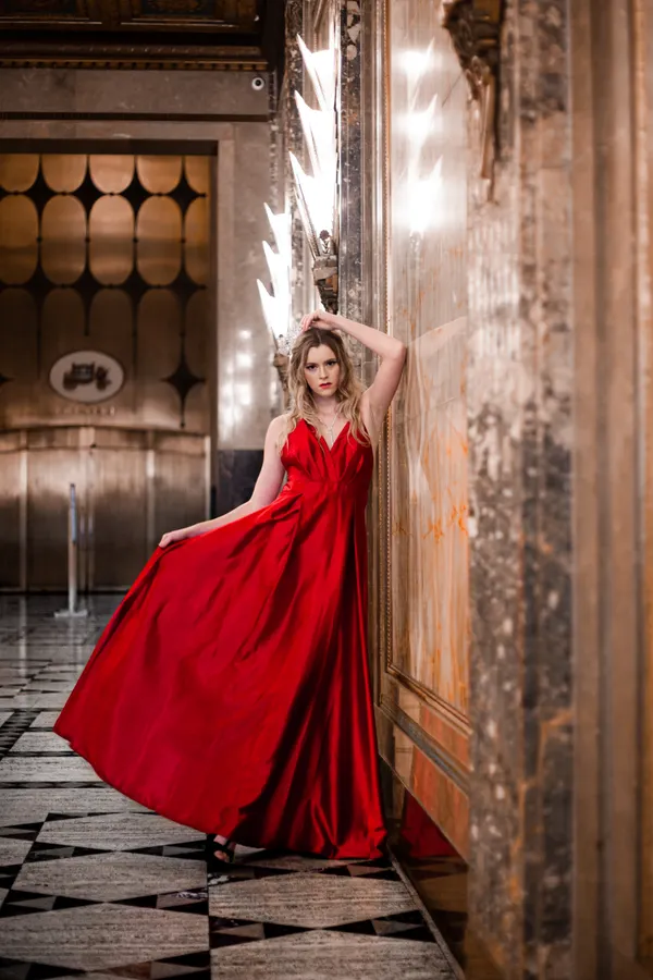 Woman wearing a red femme fatale baddie Halloween costume with gloves