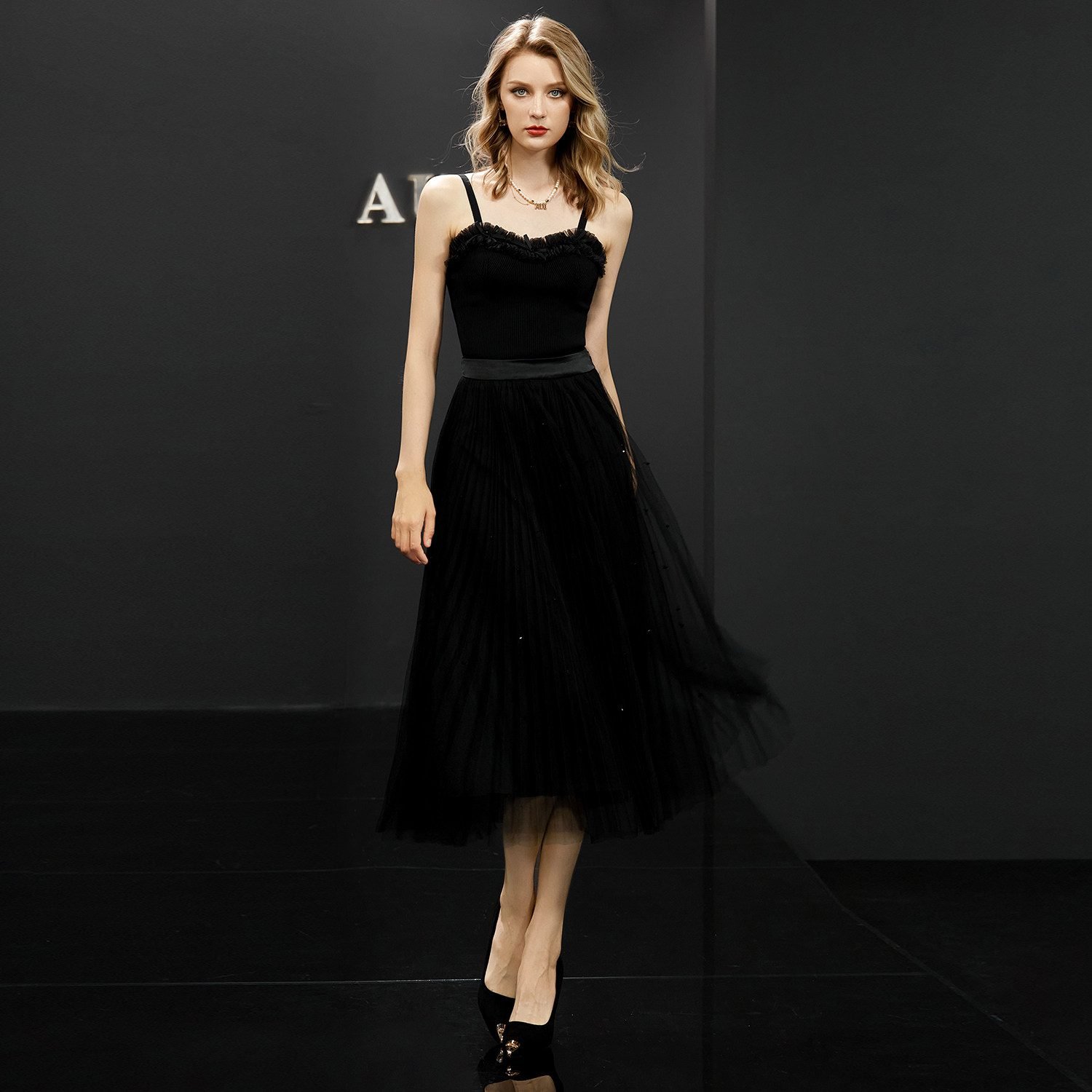 Woman in a black tulle skirt with a fitted black top