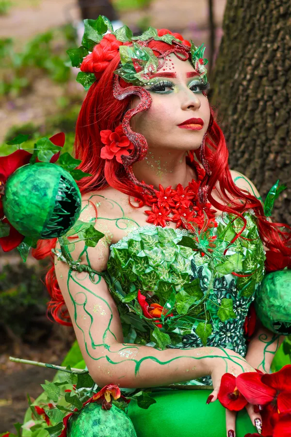 Woman in a Poison Ivy baddie Halloween costume with leaves