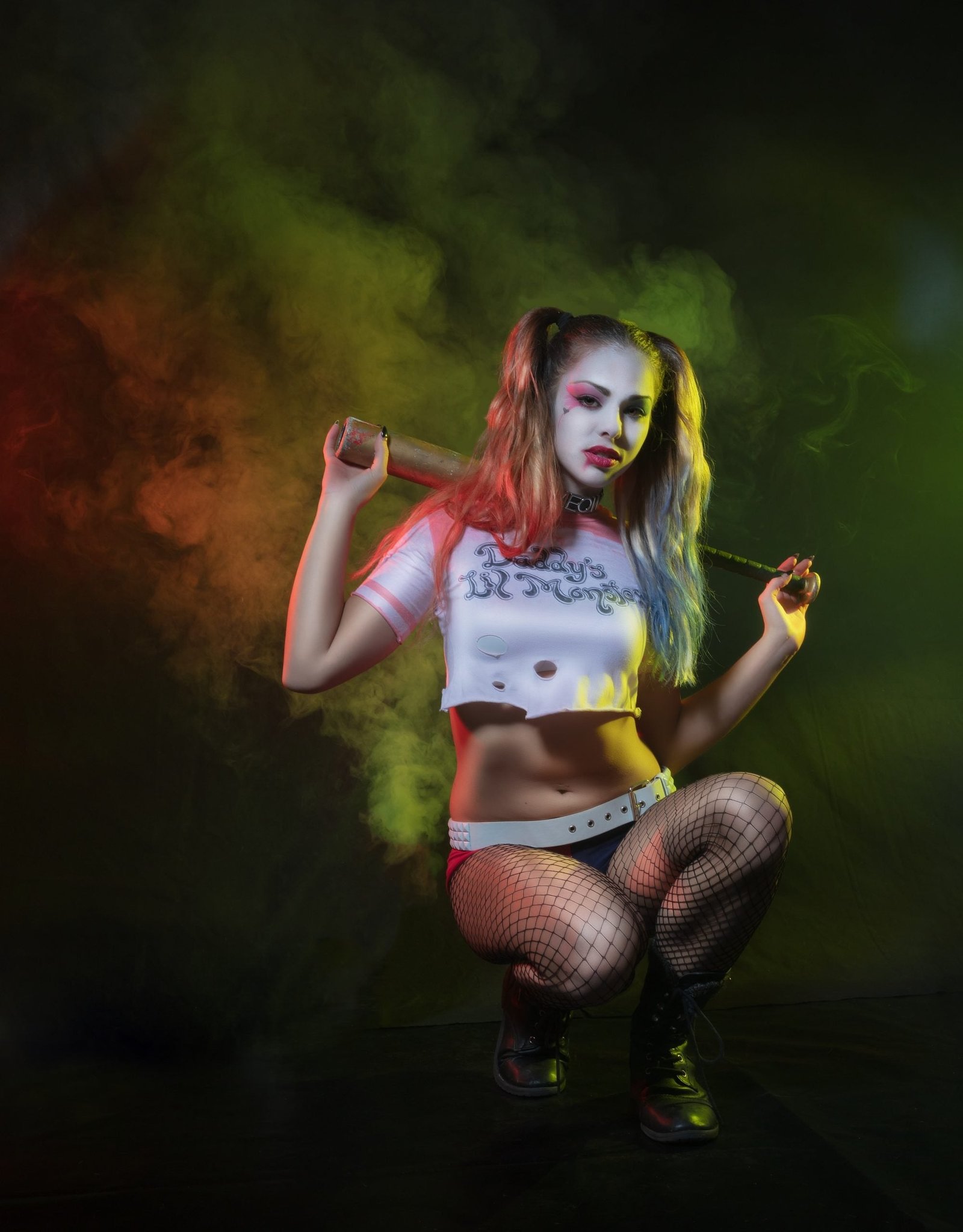 Woman dressed as Harley Quinn baddie Halloween costume with pigtails
