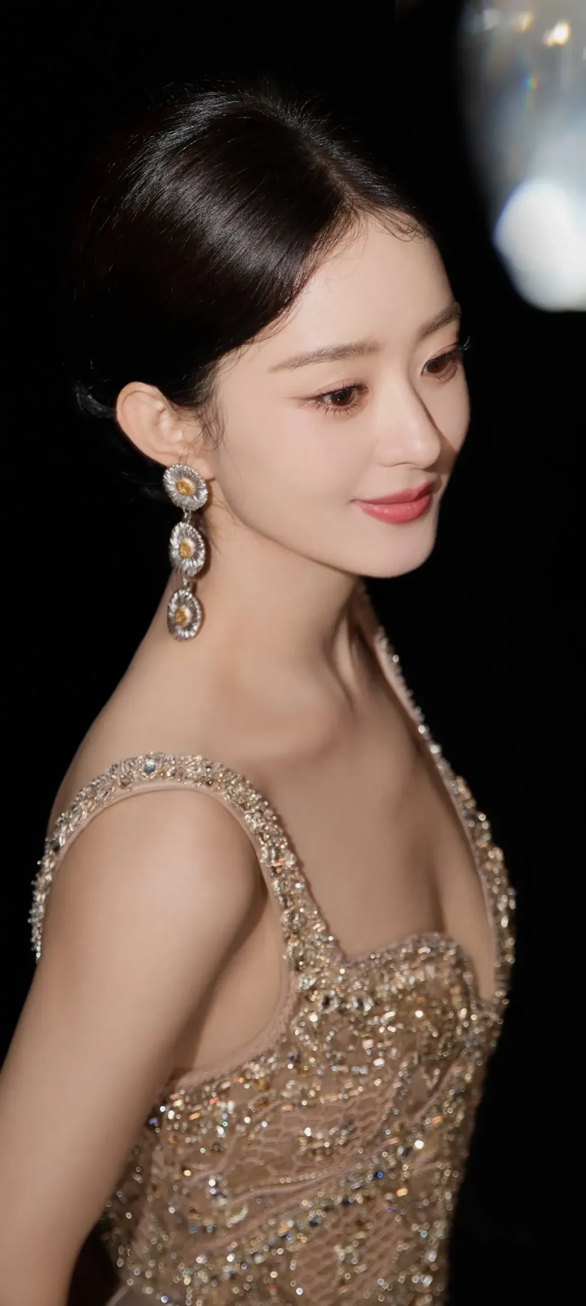 Woman wearing an evening gown with star drop earrings