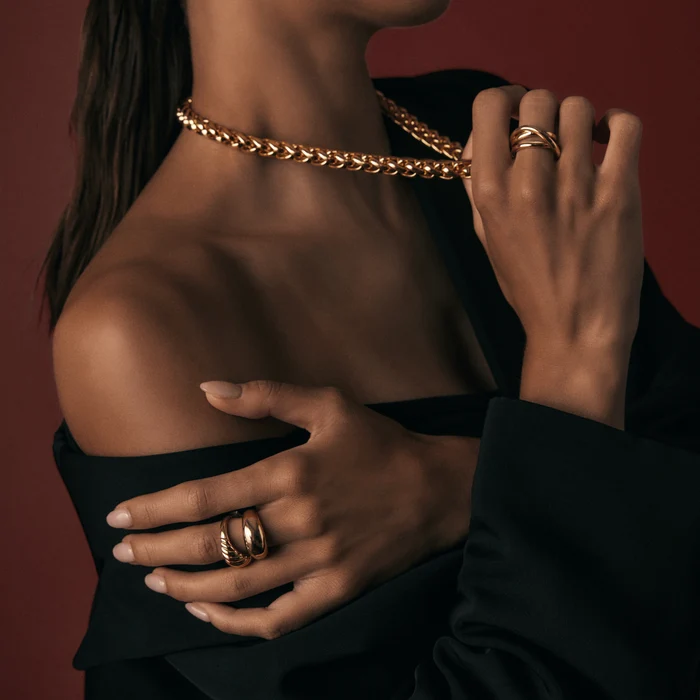 Woman wearing a minimalist black outfit with stacked celestial rings