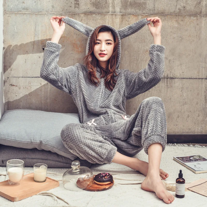 Woman wearing cute onesie pajamas at home