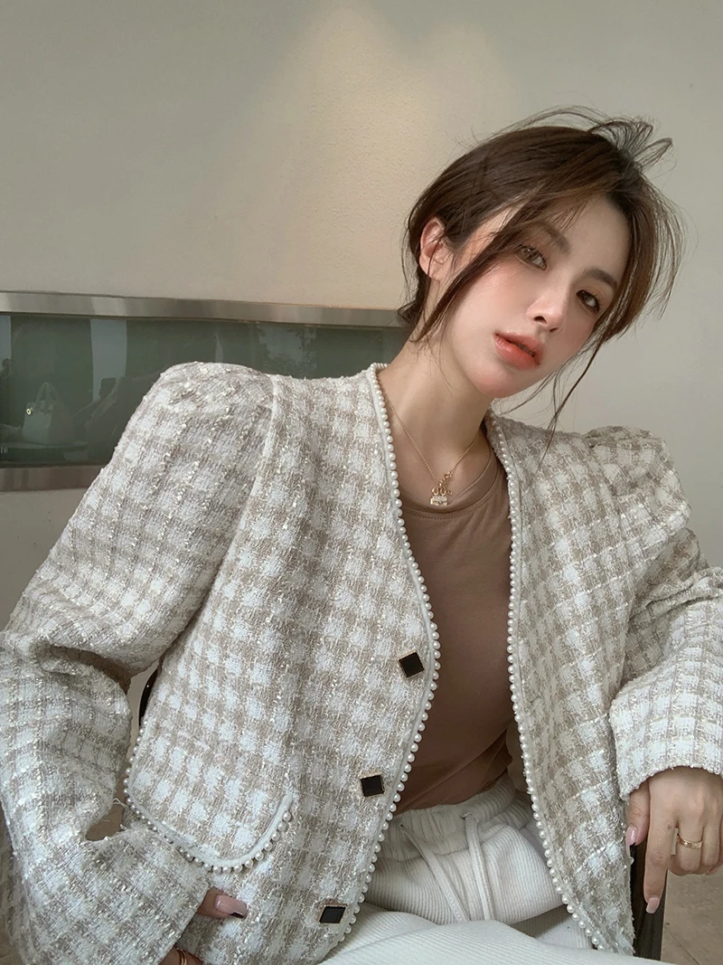 Woman in puff-sleeve blouse with tweed jacket