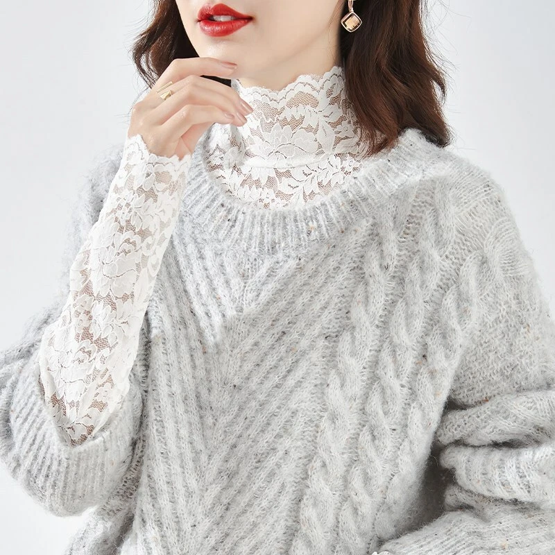 Woman in lace-collar blouse under chunky knit sweater