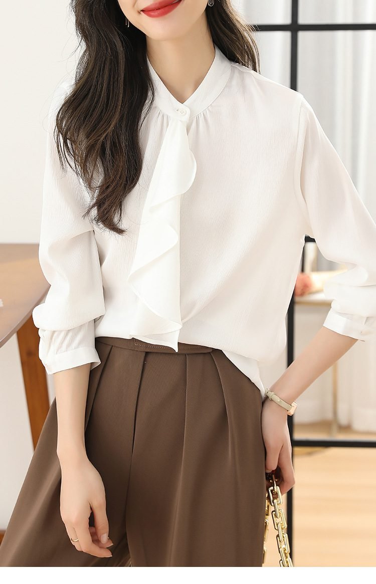 Woman in ruffled blouse with high-waisted trousers