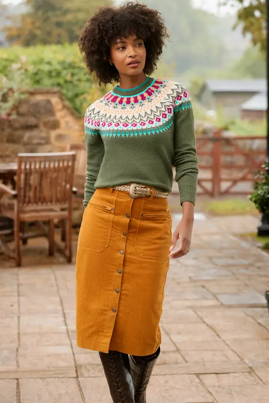 Woman in Fair Isle sweater with corduroy skirt