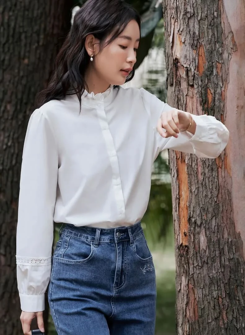 Woman in white peasant blouse with dark jeans