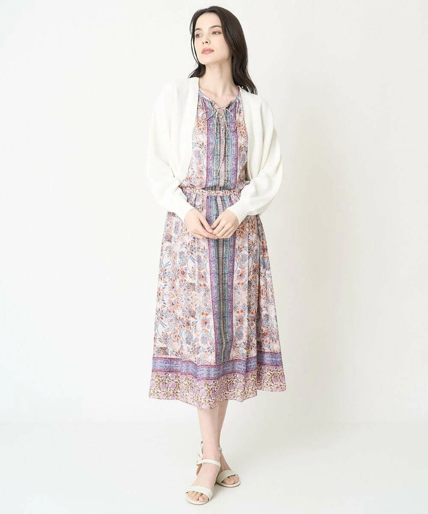 Woman in floral midi dress with cropped cardigan