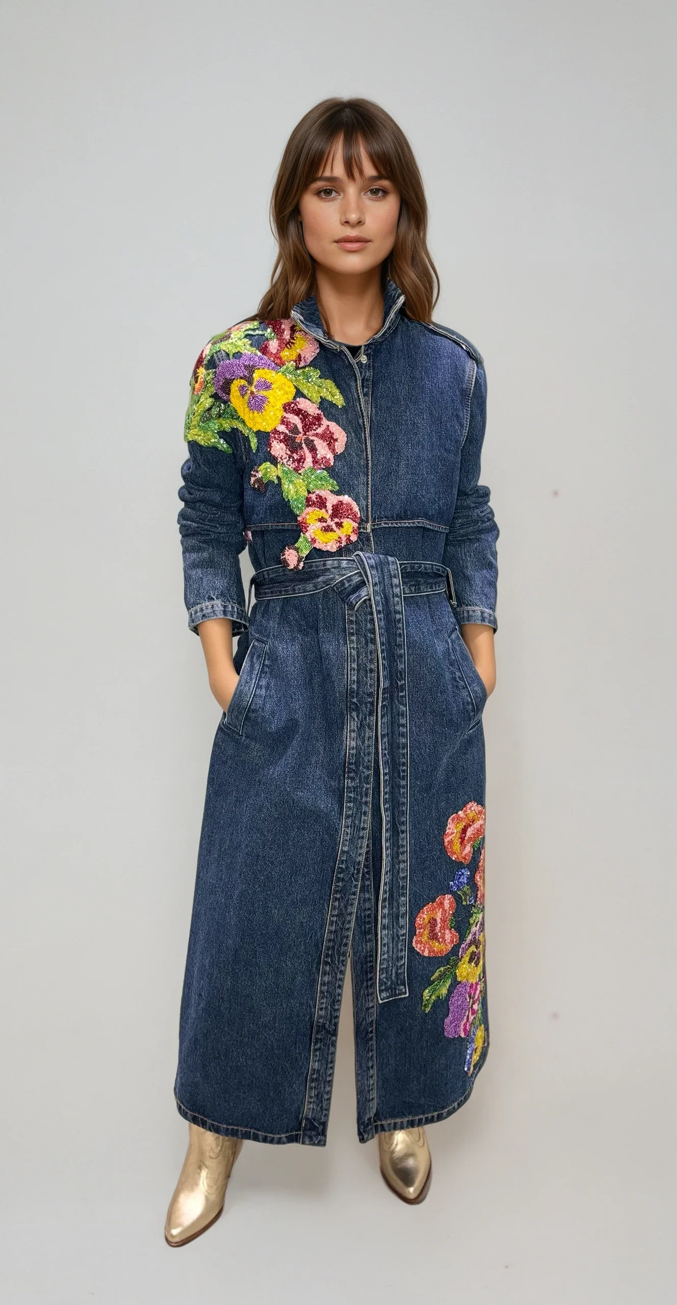 Woman in embroidered denim jacket over floral dress