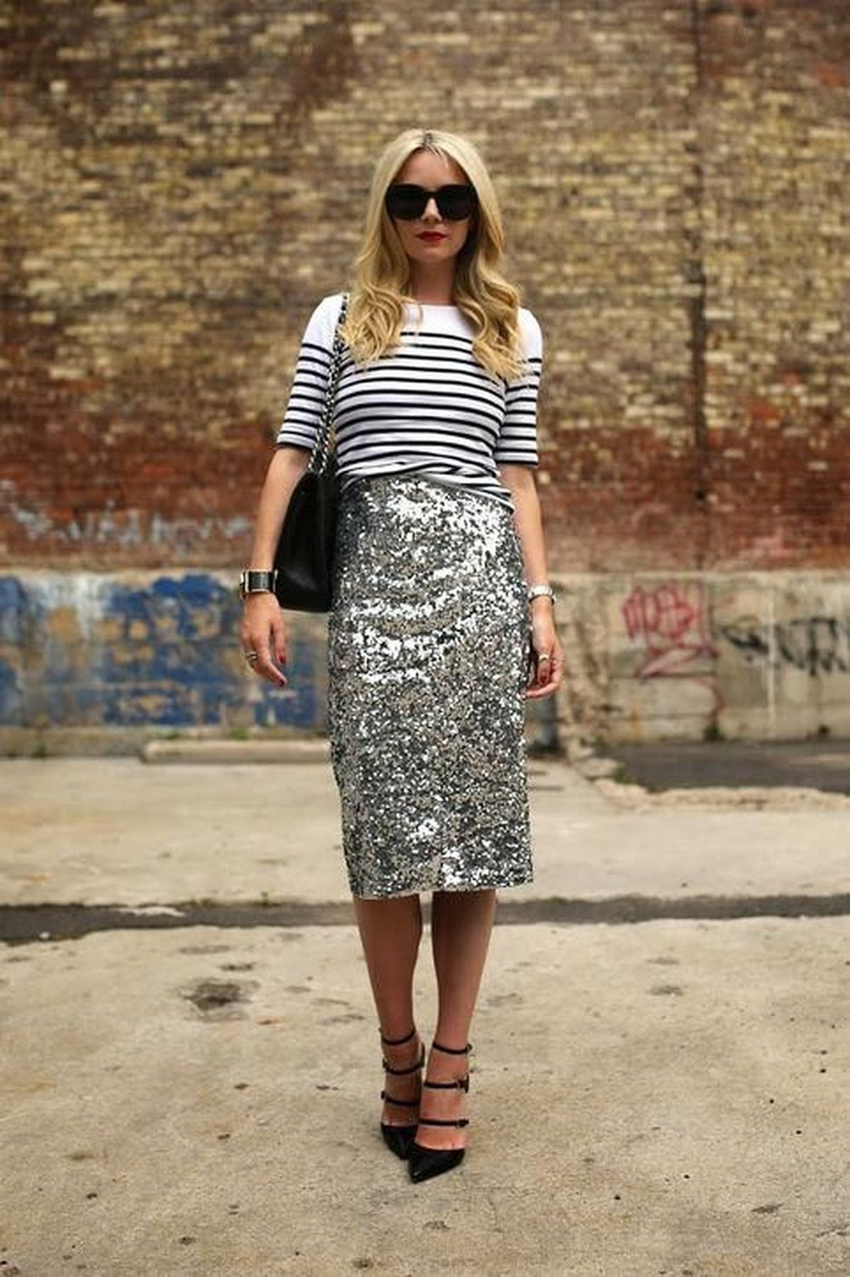 Woman in a sequin midi skirt with loafers and a tucked-in sweater