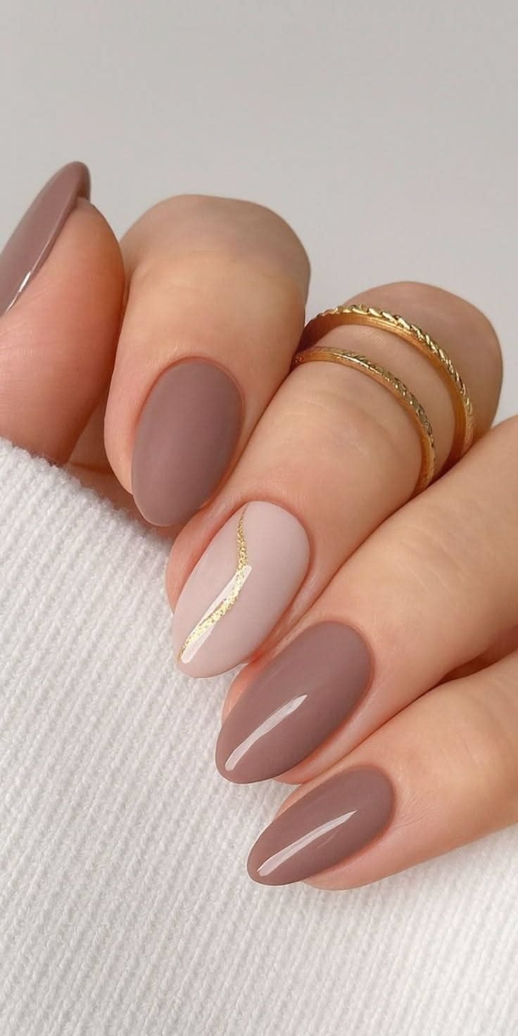 Short taupe nails with gold foil accents